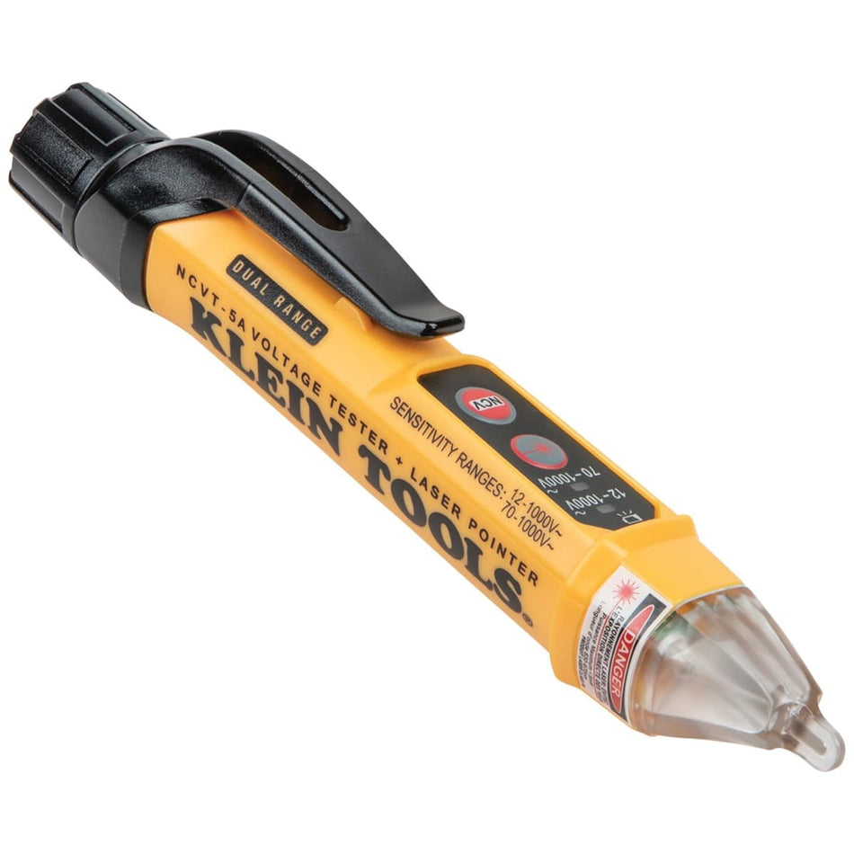 An angled studio shot of the Klein Tools NCVT5A dual-range non-contact voltage tester pen featuring a high-visibility yellow body with black accents. The image showcases the integrated laser pointer button, dual-mode range selection interface, and the clear sensing tip with a "Danger" laser radiation warning label.