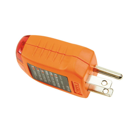 A side profile of the Klein Tools RT110 highlighting the rugged industrial construction. The image emphasizes the textured grip on the sides and the standard electrical prongs designed for easy insertion into grounded 120V AC wall receptacles.