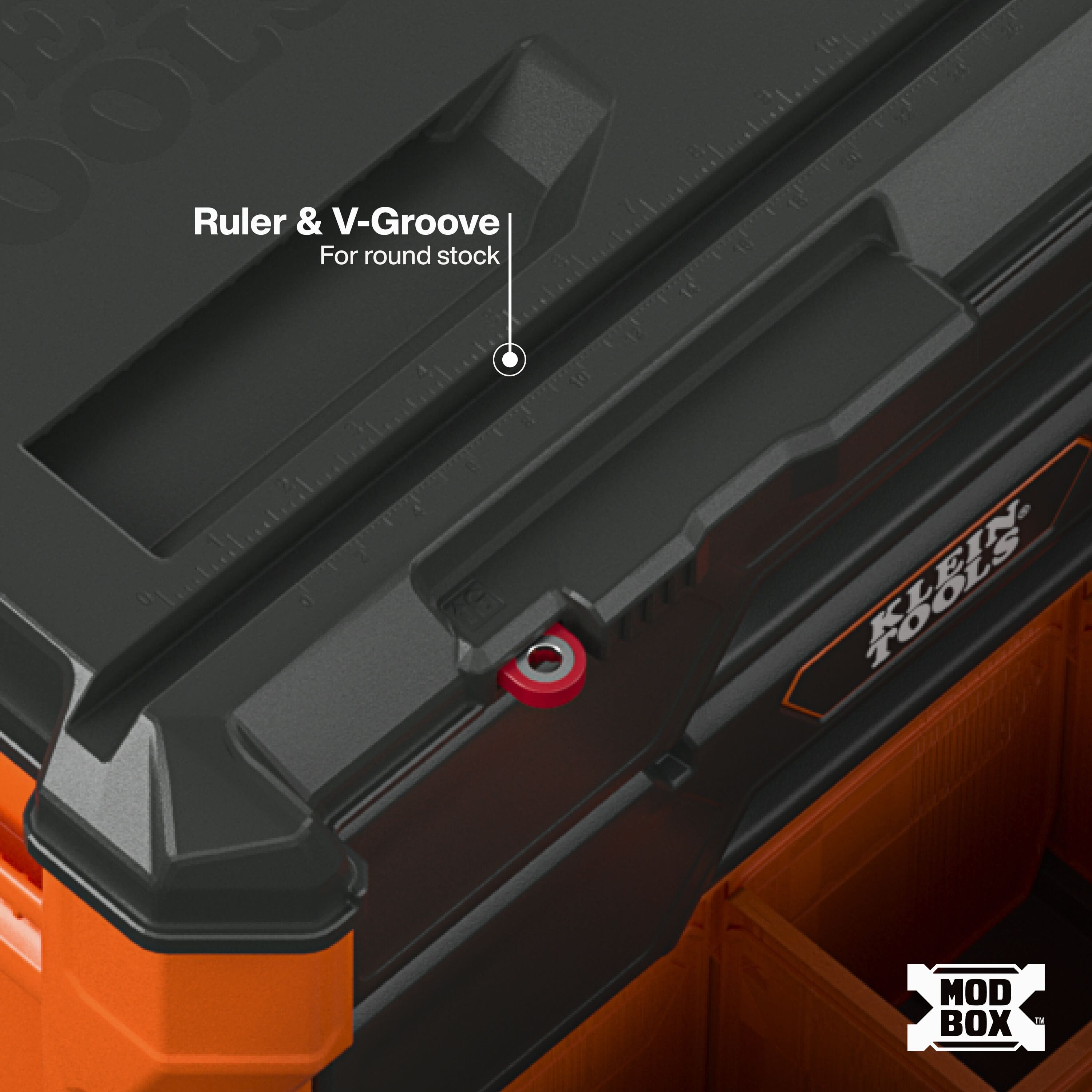 Integrated lid ruler and V-groove channel on the Klein MODbox secure conduit, pipe, and round stock for precise jobsite cutting.