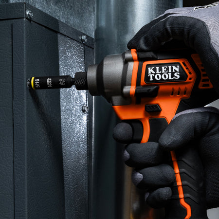 HVAC mechanic using an impact driver with the Klein Tools 5/16-inch color-coded nut driver bit to secure a sheet metal ductwork panel screw.