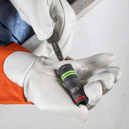 Lineman in insulated safety gloves connecting the 1/2 to 3/8-inch drive adapter into the Klein 66044 slotted flip socket.