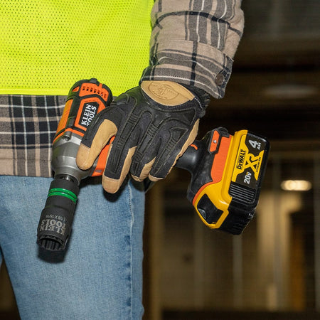 Technician carrying a 1/2-inch impact wrench equipped with a Klein 1-1/8 by 15/16-inch slotted coaxial socket for overhead utility work.