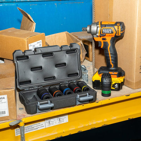 Klein 66090 socket set arranged on a jobsite shelf beside a 1/2-inch impact wrench to organize tools for power utility pole maintenance.
