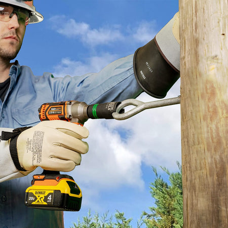 Utility lineman using a slotted socket on a cordless impact wrench to turn a curved eyebolt on a wooden utility pole.
