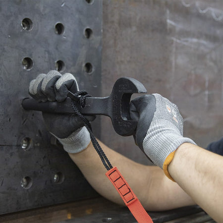 Ironworker inserting the 3214TT tapered handle into a multi-hole steel connection plate to align overlapping bolt holes on a jobsite.