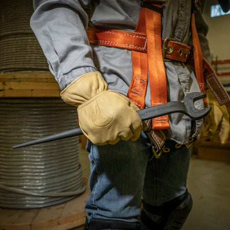 Ironworker holding the Klein 3222 spud wrench showing the continuous handle taper designed to slide into bolt holes without binding.