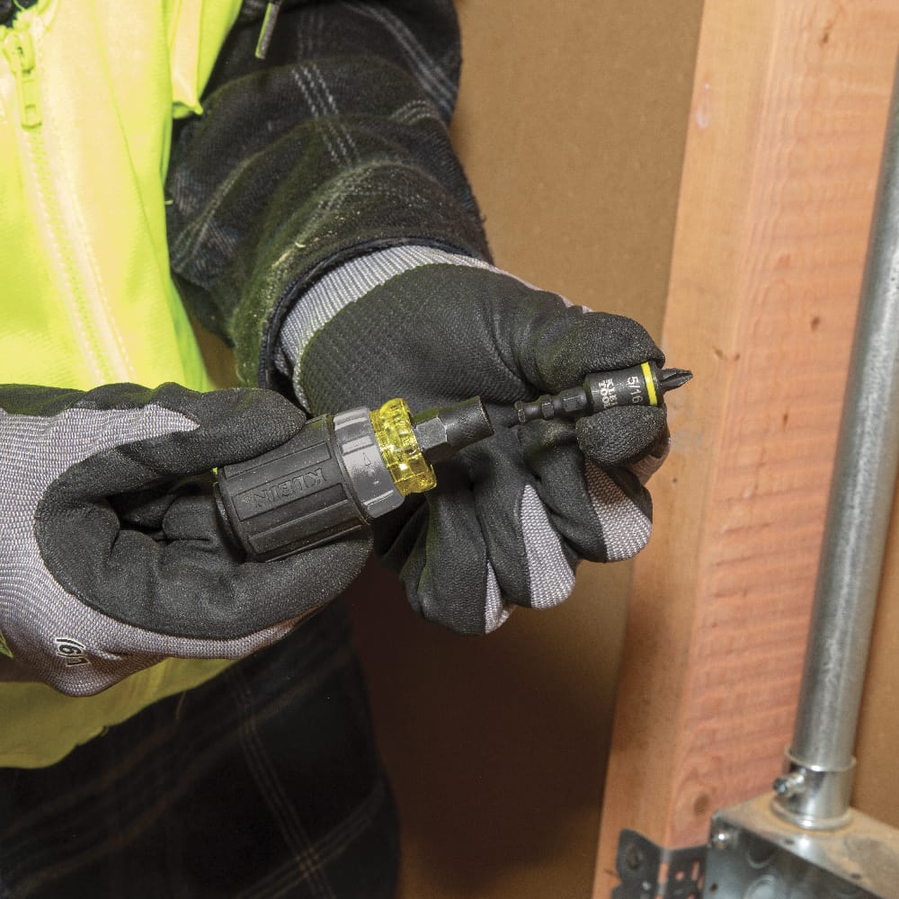 Electrician inserting a 5/16-inch impact-rated nut driver bit into the Klein Tools 32561HDRT stubby handle KNECT collet interface.