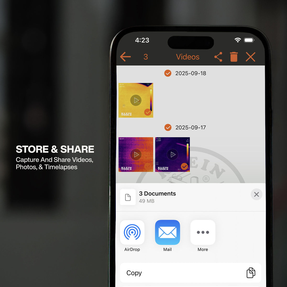A smartphone screen showing the store and share functionality of the Klein Tools thermal imaging app. The interface displays a library of captured thermal videos and photos with options to share professional diagnostic reports via AirDrop, Mail, and other platforms.