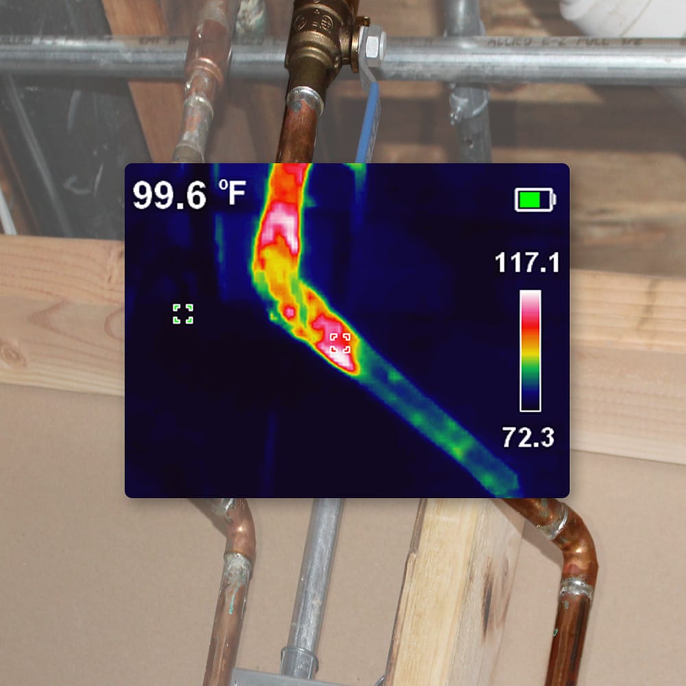Action shot demonstrating the TI250 thermal camera inspecting copper plumbing pipes. The high-resolution infrared sensor identifies a hot water line at 99.6 degrees Fahrenheit, showcasing the tool's effectiveness in locating leaks or verifying temperature differentials in professional plumbing systems.