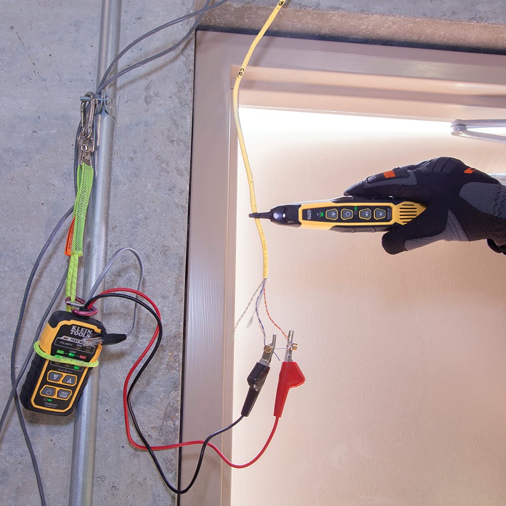 Action shot demonstrating the use of the VDV500123 tracing probe in a high-density network rack. The technician is shown using the probe to locate a single data cable among hundreds, highlighting the tool's precision in complex server room environments.
