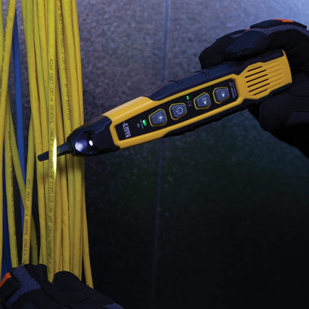Action shot of a professional using the Klein Tools Probe-PRO with standard headphones connected via the 3.5mm jack. This setup demonstrates how technicians can accurately hear tracing tones in loud mechanical rooms or busy jobsites without ambient noise interference.
