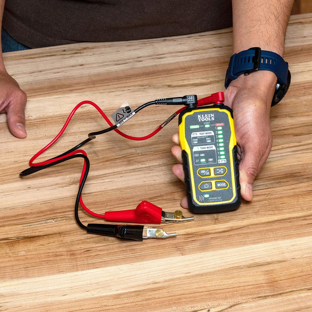 Full product kit view of the VDV500163 featuring the handheld digital tone generator and its professional accessories. The set includes heavy-duty ABN test leads and a standard RJ45-to-RJ45 patch cable, providing a complete solution for wire identification and tracing.