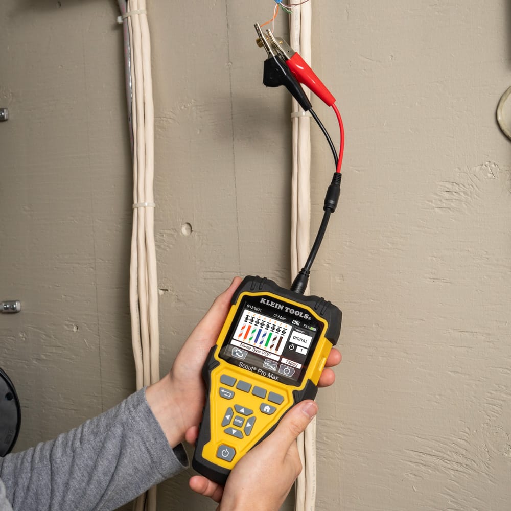 Action shot of the Scout Pro Max performing a data speed and PoE test on an active network switch. The technician monitors the real-time diagnostic results on the full-color backlit screen, ensuring the live network installation meets the required specifications for voltage and data throughput.