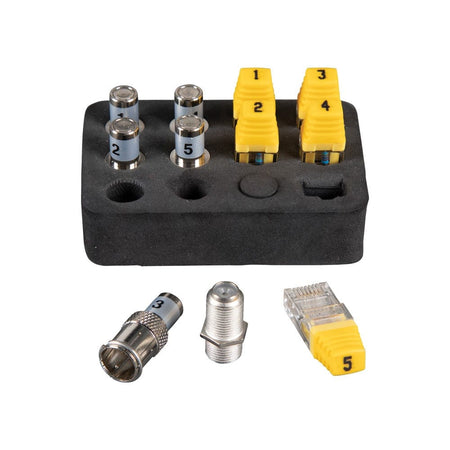 A black foam organizer holding five silver-toned CoaxMap location remotes and five yellow LanMap RJ45 location remotes, each numbered 1 through 5. Below the organizer are three loose components: a BNC to F-adapter, an F-connector coupler, and a single yellow RJ45 remote numbered 5.