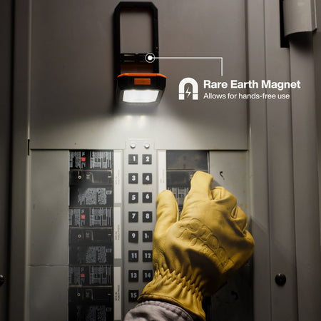 Electrician using the Rare-Earth magnetic mount on Klein 56079 work light to magnetically attach it overhead inside a steel breaker box.
