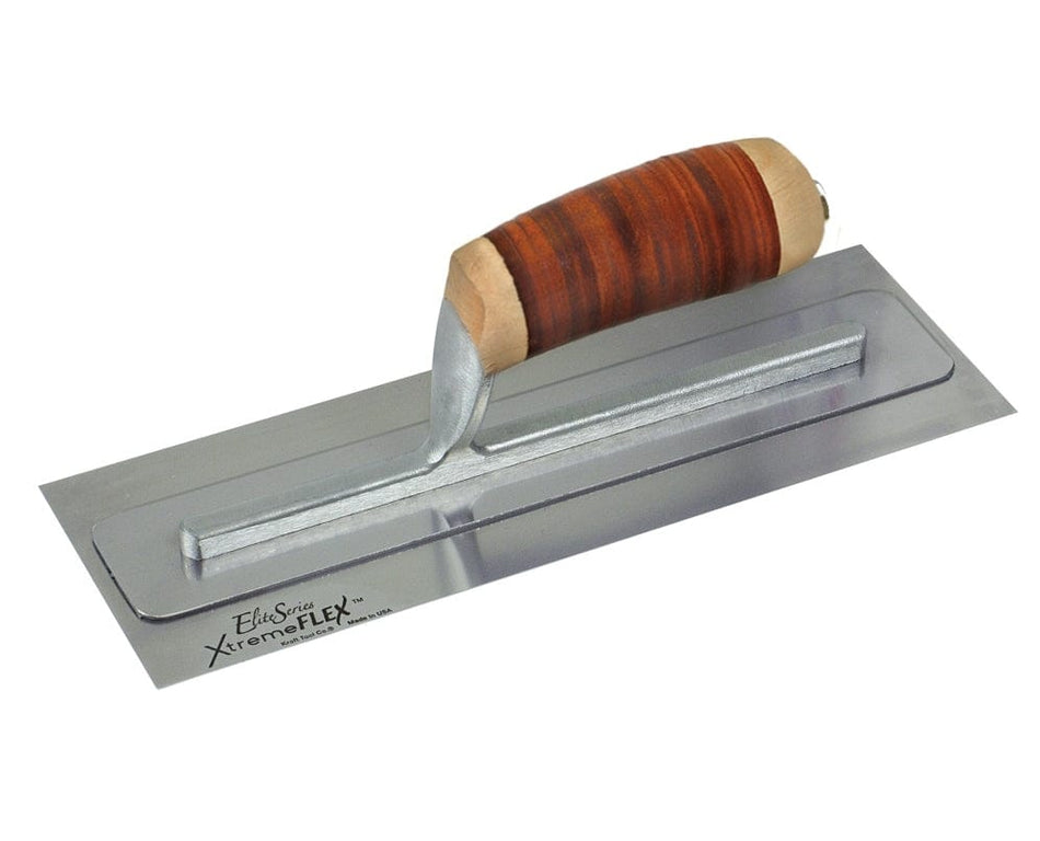 Studio view of the Kraft Tool Elite Series XtremeFLEX finishing trowel featuring a stainless steel blade with a top support plate and a contoured brown leather handle.