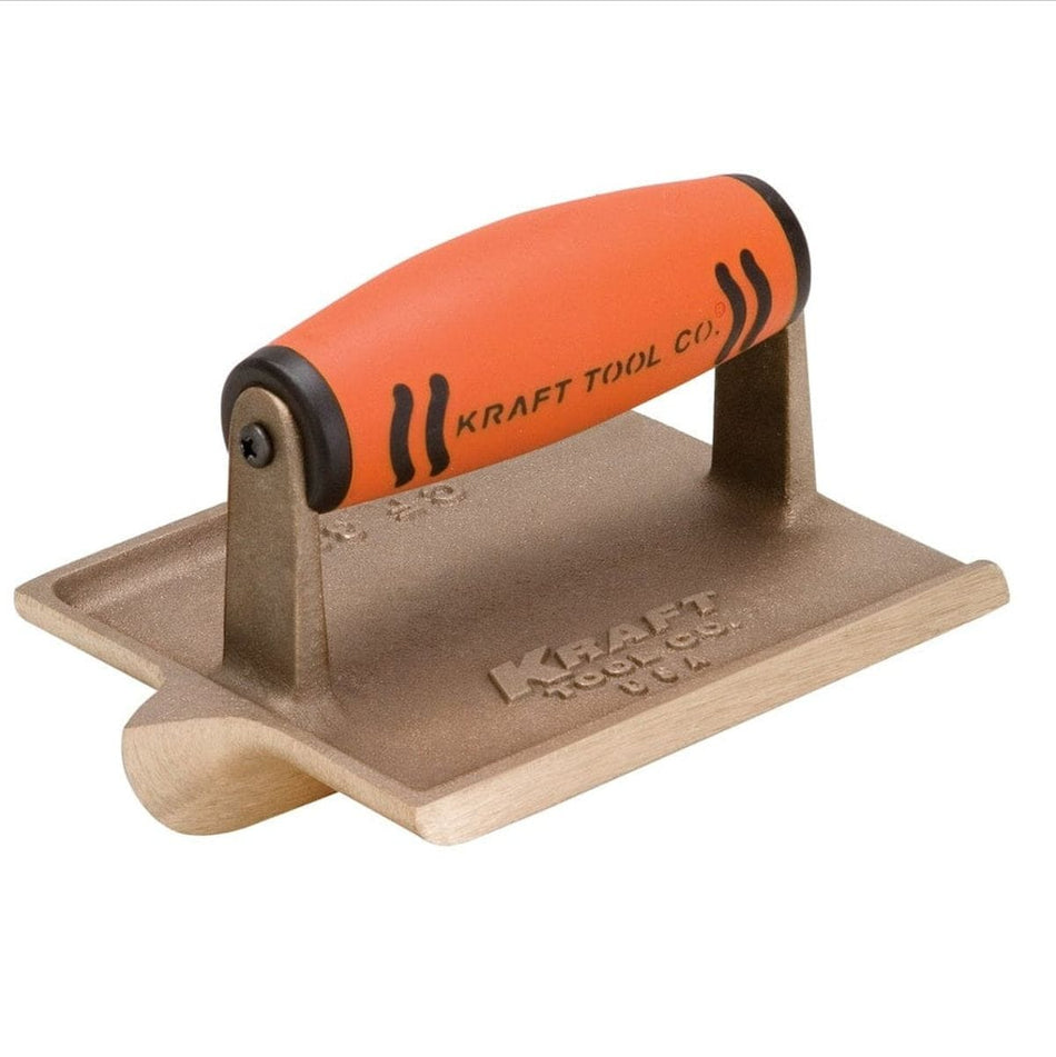 Angled studio view of the bronze hand groover featuring the orange ProForm handle and the deep cutting bit extending from the base.