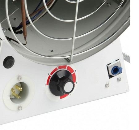 Close-up detail of the heater's control panel showing the variable thermostat dial with settings 1 through 7 and the standard 3-prong power inlet socket.