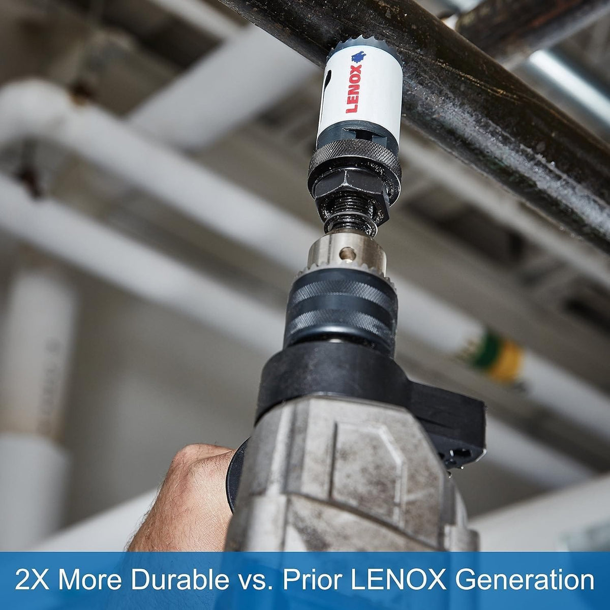 Tradesman utilizing a LENOX bi metal hole saw attached to a power drill to cut into a heavy metal pipe overhead, highlighting the high speed steel construction that is two times more durable than prior generations for industrial conduit routing.