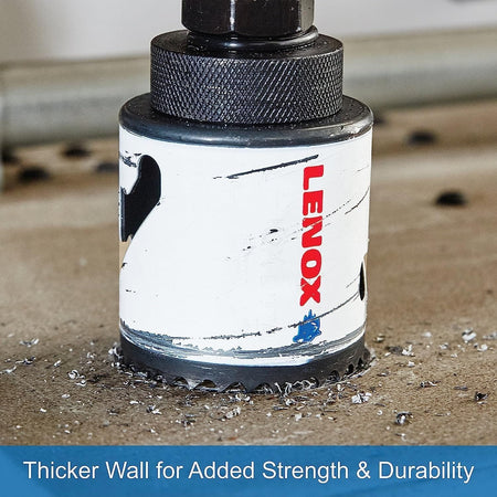 Close up of a LENOX high speed steel bi metal hole saw penetrating a flat metal surface surrounded by metal shavings, illustrating the thicker wall design engineered for added strength and durability during heavy duty structural drilling.