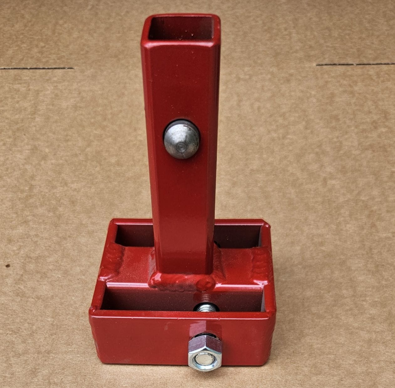Front view of the Little Beaver 30320-C centered mobile home anchor adapter featuring a durable red powder-coated steel finish and a pre-installed securing pin for high-torque applications.