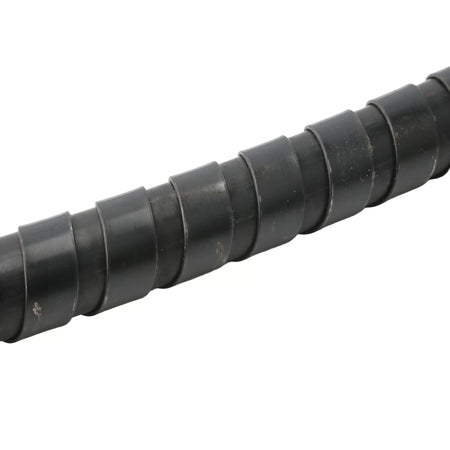 Macro close-up view of the interlocking black steel spiral ribbon coil wrapped around the flexible drive shaft casing, engineered to absorb high torsional friction and block internal cable buckling under heavy loads.