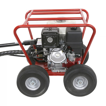 A close-up view of the commercial Honda engine and carburetor assembly on the Little Beaver earth drill power head machine, emphasizing heavy-duty components and all-terrain wheels.