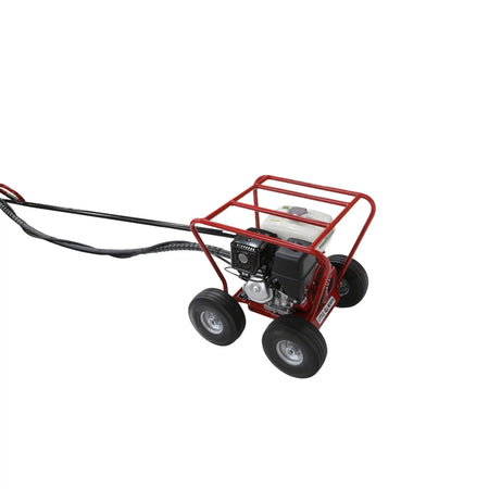 High-angle wide-perspective studio photo showing the full relative length of the black flexible mechanical drive shaft line trailing outward from the red four-wheel engine carriage.
