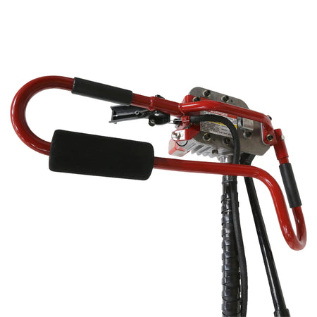 Under-side perspective view looking up at the remote mechanical operator handlebar configuration, highlighting the red tubular steering grips, integrated safety throttle lever trigger switch, and gearbox mounting base.