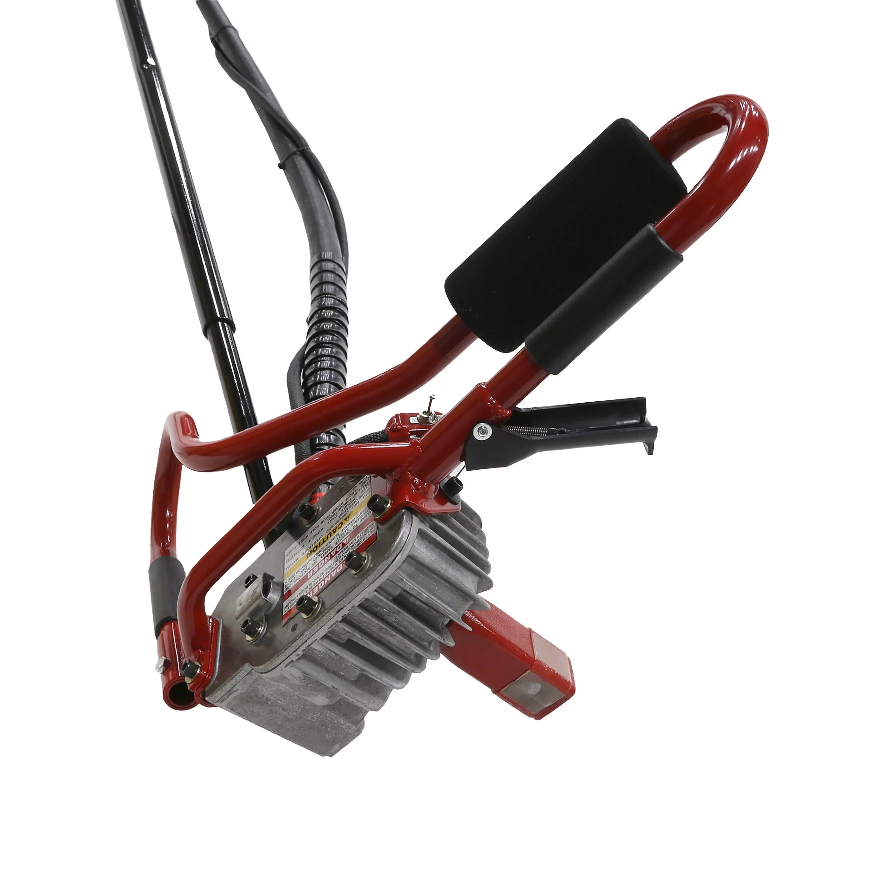 Angled downward studio shot focusing on the cast-aluminum mechanical gearbox housing assembly of the remote operator handles, displaying cooling fins, control levers, and the prominent safety decal array.