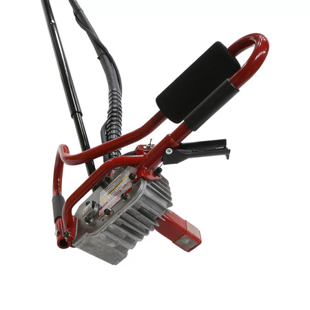Angled downward studio shot focusing on the cast-aluminum mechanical gearbox housing assembly of the remote operator handles, displaying cooling fins, control levers, and the prominent safety decal array.