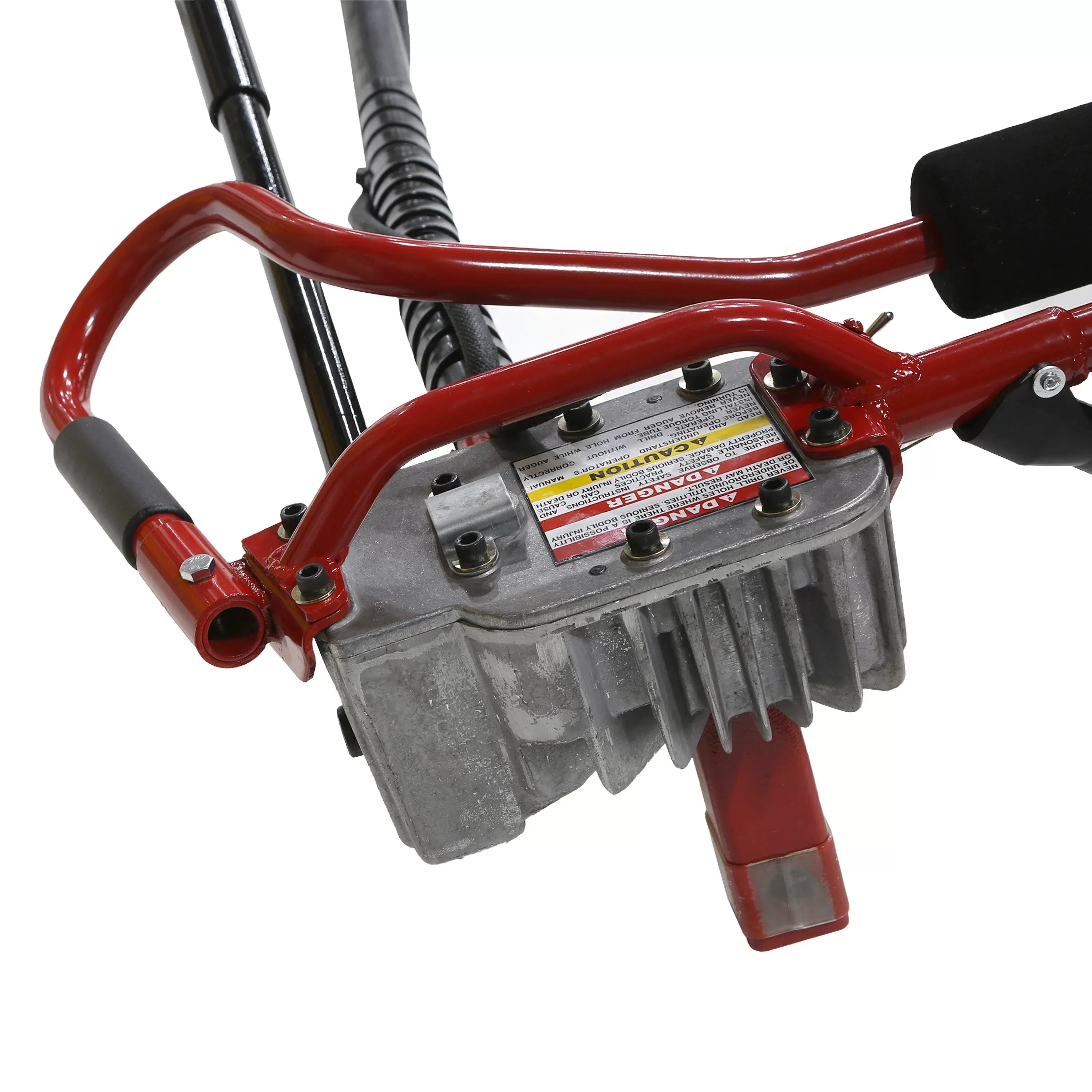 Close-up detailed image of the heavy-duty cast aluminum gear reduction transmission head located on the operator handle assembly, featuring prominent hazard warning texts and structural hex bolts.
