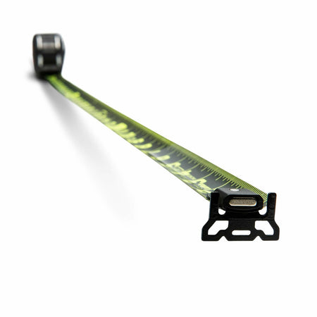 A low-angle studio shot of the Lufkin Shockforce G2 Nite Eye tape measure. The black and green blade is extended towards the viewer, showing the magnetic, diamond-coated end hook in sharp focus.