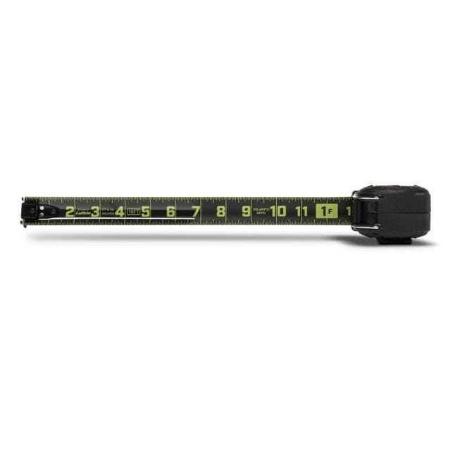A top-down studio shot of the Lufkin Shockforce G2 tape measure. The black and green Nite Eye blade is extended horizontally, showing clear SAE markings up to the 1-foot mark.