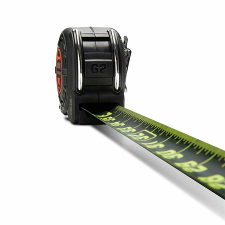A top-down studio shot looking from the back of the Lufkin Shockforce G2 tape measure. The black and green Nite Eye blade, showing metric markings on its underside, is shown extending away from the case.
