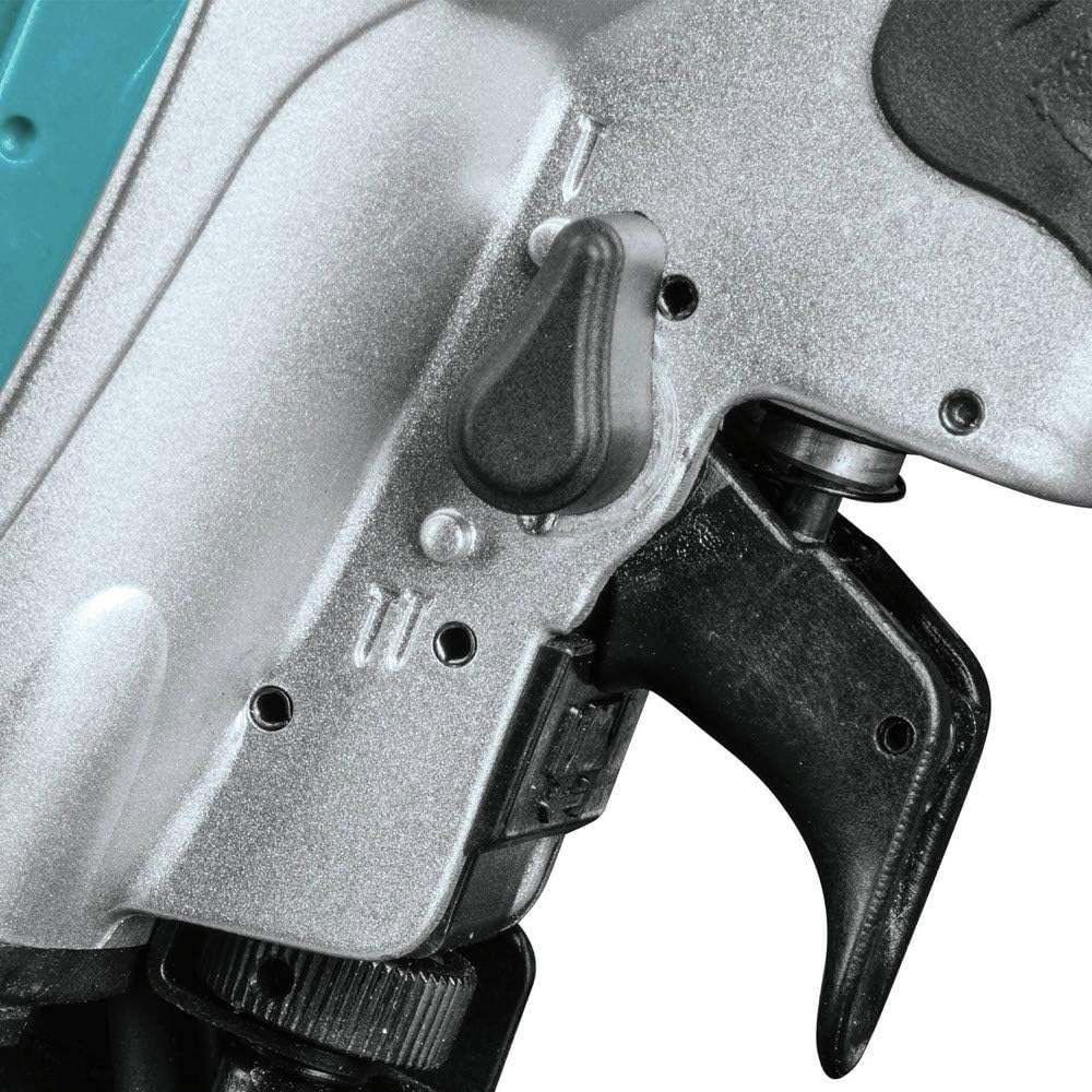 A close-up studio shot of the 2-mode selector switch located just above the trigger on the Makita AN454 nailer.