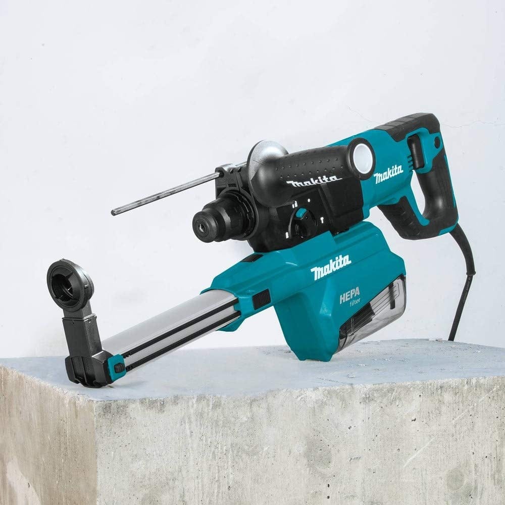 Makita HR2661 rotary hammer drill with HEPA filter system shown on concrete surface. Includes side handle, depth gauge, and visible branding for dust-controlled drilling.