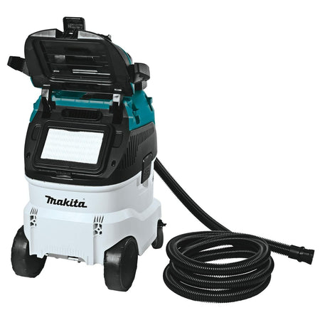 Makita VC4210L vacuum with open lid and visible pleated filter, shown with coiled hose and connector, emphasizing internal components and tool compatibility.