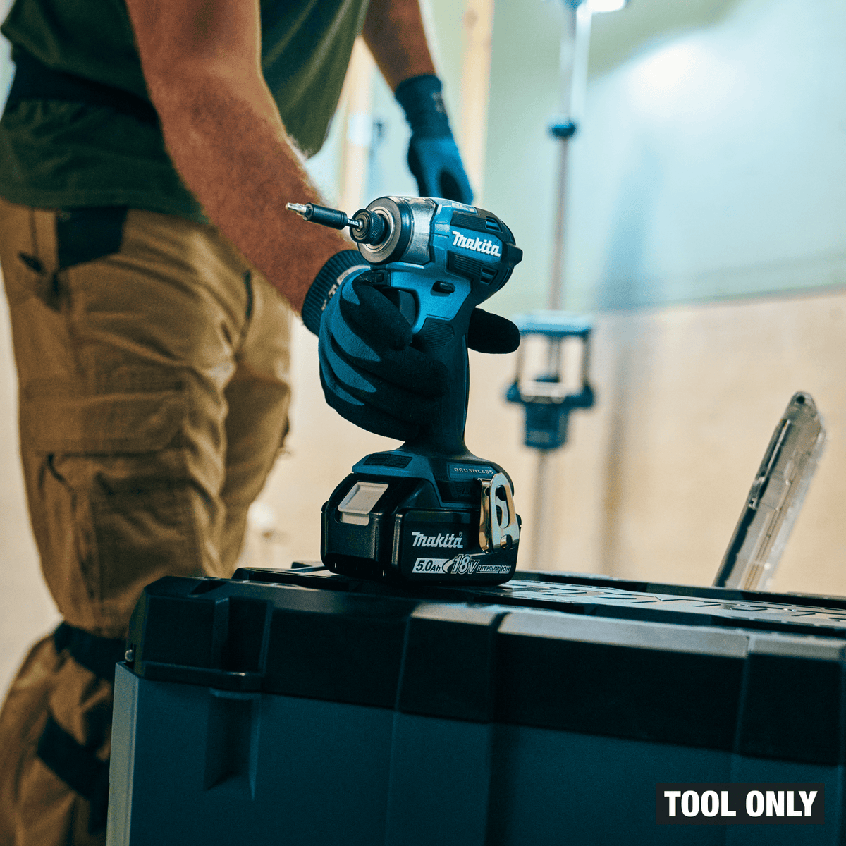 Makita XDT20 18V LXT cordless impact driver resting on an interlocking jobsite tool box ready for structural fastening.