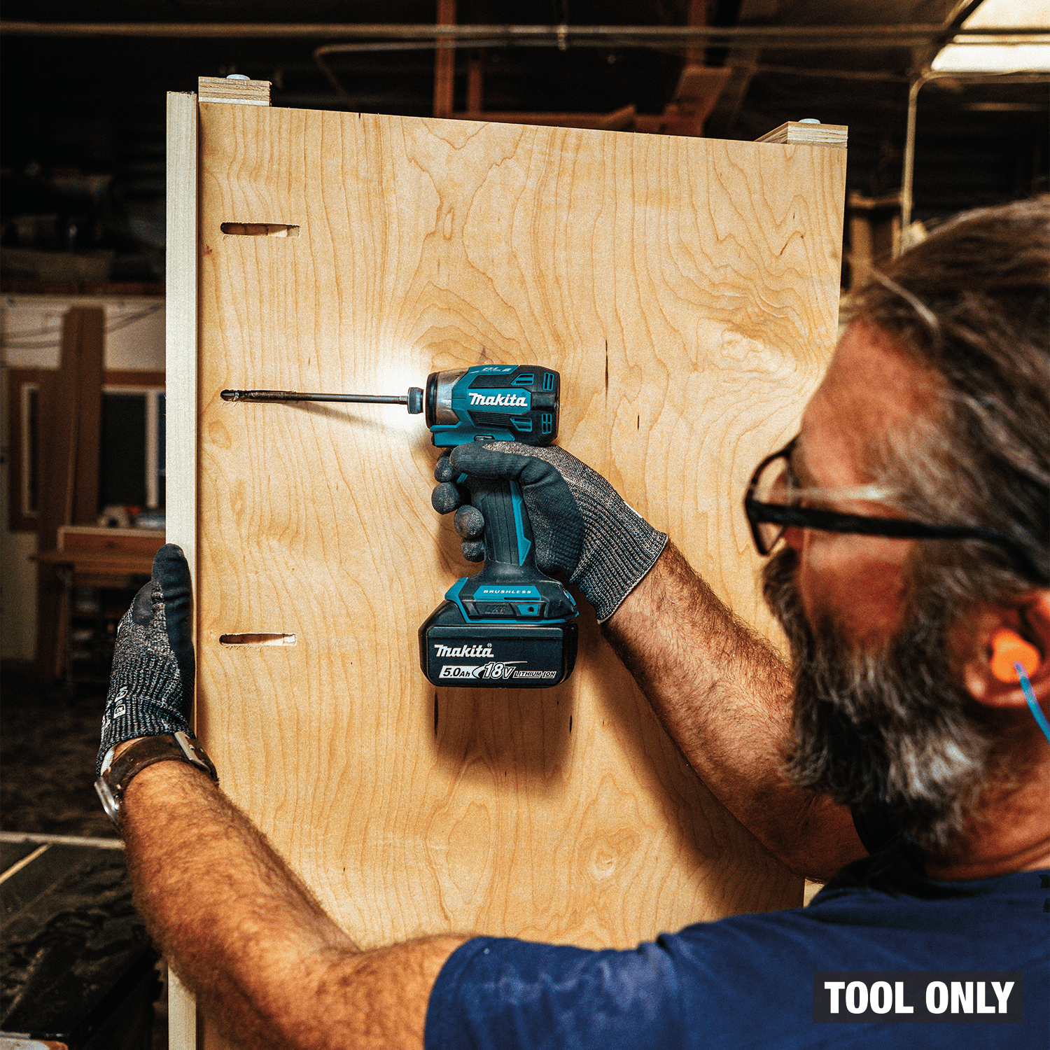 Woodworker driving pocket hole screws into birch plywood cabinetry using the compact Makita XDT20 impact driver.