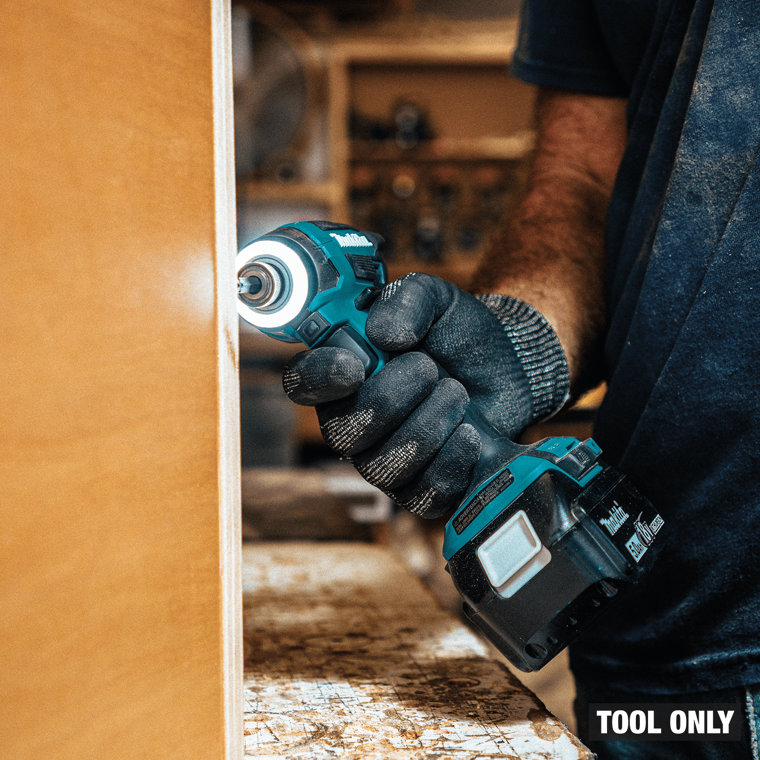 Cabinetmaker maneuvering compact Makita XDT20 4-1/2-inch impact driver with LED ring inside a tight corner joint.