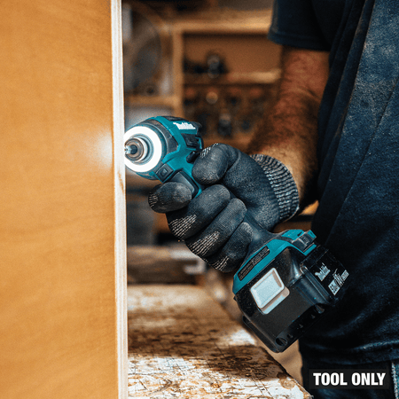 Cabinetmaker maneuvering compact Makita XDT20 4-1/2-inch impact driver with LED ring inside a tight corner joint.