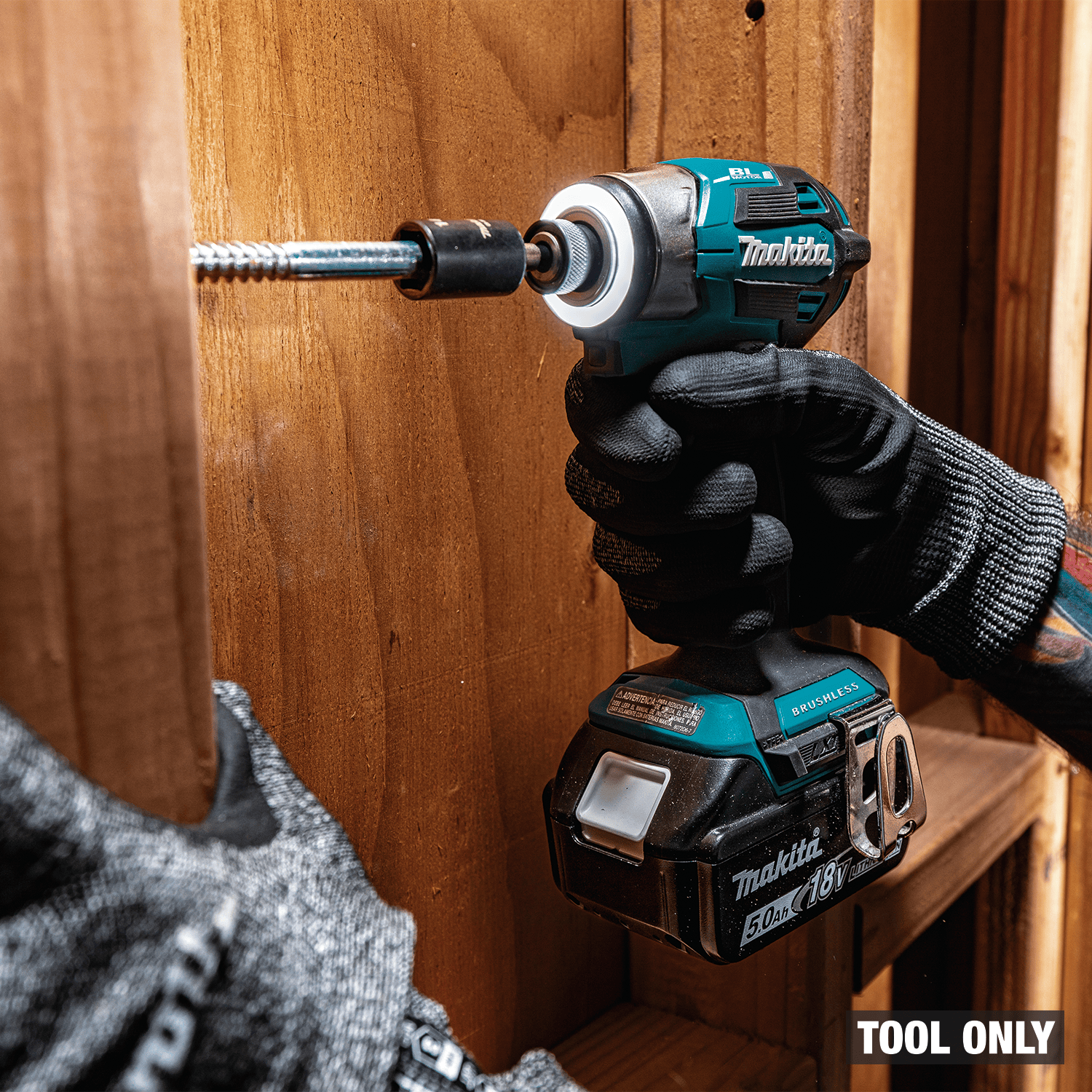Makita XDT20Z 18V impact driver driving heavy timber lag screws into solid wood framing with 1,590 in-lbs torque.