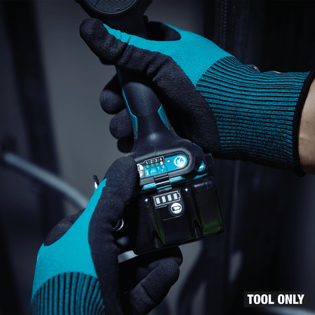 Tradesperson selecting impact power modes on the base panel of the Makita XDT20 18V LXT cordless impact driver.