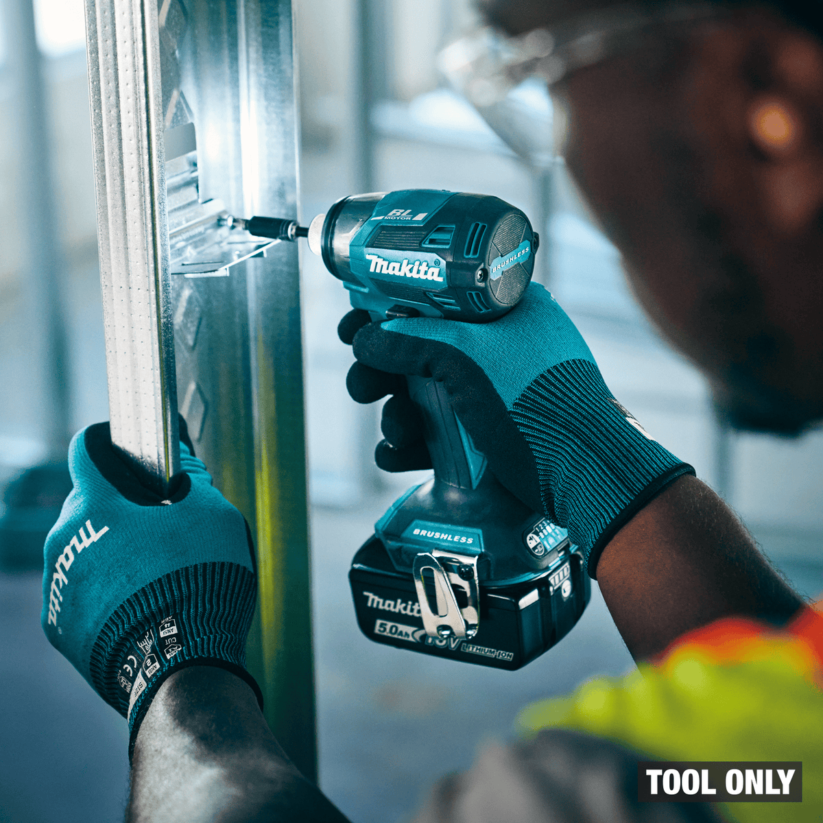 Makita XDT20 impact driver driving self-drilling screws into steel framing studs using Tightening Mode precision.