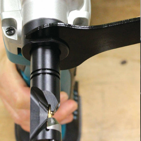 A close-up of the Makita nibbler's punch and die, showing a wrench being used to make an adjustment.
