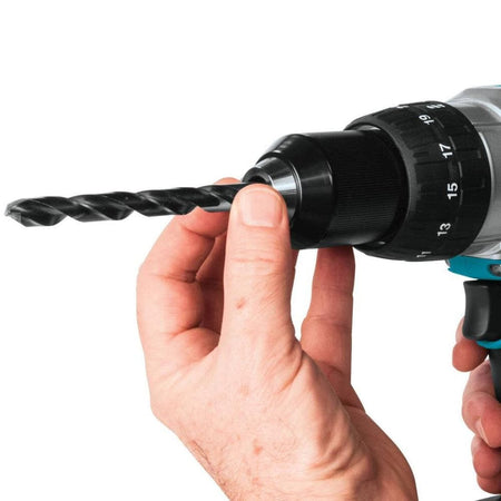 Hand holding a drill with a drill bit attached on a white background