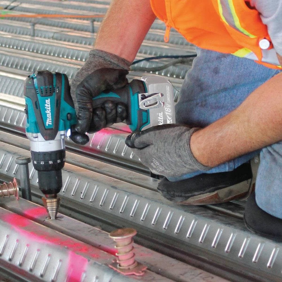 Person using Makita power tools on metal framing