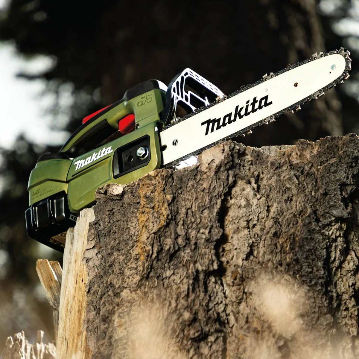 Side perspective of the Makita brushless top handle chain saw on a log, highlighting the slim profile and direct-drive system for professional-grade wood cutting.