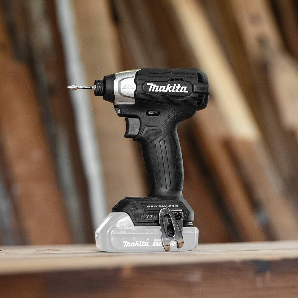 The Makita XDT18ZB impact driver resting on a wooden workbench in a workshop setting.